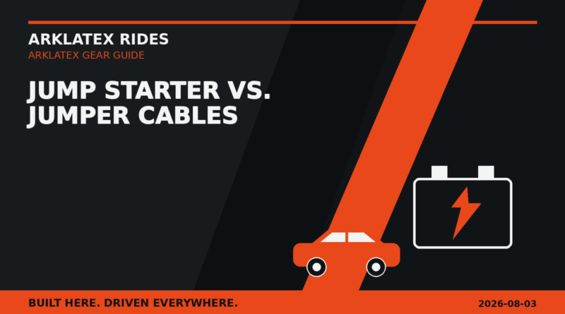 Portable jump starter and heavy jumper cables beside a dark pickup with orange lightning graphics